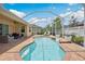 Screened-in pool and deck area with backyard patio furniture and landscaping at 3227 Watermark Dr, Wesley Chapel, FL 33544