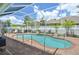 Screened-in pool with brick surround, safety fence, and patio furniture at 3227 Watermark Dr, Wesley Chapel, FL 33544