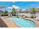 Screened-in pool with brick surround, lounge chairs, and lush landscaping at 3227 Watermark Dr, Wesley Chapel, FL 33544