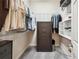Walk-in closet with custom shelving and hanging racks featuring a safe for storage and organization at 3227 Watermark Dr, Wesley Chapel, FL 33544