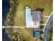 Aerial view of the community pool, clubhouse, and pier on the lake at 3300 Stonegate Falls Dr, Land O Lakes, FL 34638