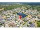 Aerial view of home in established community with large pond, mature landscaping, and tree-lined streets at 3300 Stonegate Falls Dr, Land O Lakes, FL 34638