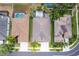 Bird's eye view of a home with backyard pool and screen, in a neighborhood with sidewalks and landscaping at 3300 Stonegate Falls Dr, Land O Lakes, FL 34638