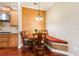 Cozy breakfast nook features a built-in bench with decorative pillows and a charming round table under a unique chandelier at 3300 Stonegate Falls Dr, Land O Lakes, FL 34638