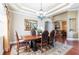 Formal dining room with decorative rug, trey ceiling, chandelier, and access to kitchen at 3300 Stonegate Falls Dr, Land O Lakes, FL 34638
