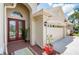 Inviting entryway featuring double glass doors and a well-manicured landscape at 3300 Stonegate Falls Dr, Land O Lakes, FL 34638
