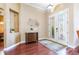 Elegant foyer features a decorative chest, rug, and decorative glass double doors at 3300 Stonegate Falls Dr, Land O Lakes, FL 34638