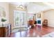 Grand foyer with gleaming wood floors leads into a living space with a fireplace at 3300 Stonegate Falls Dr, Land O Lakes, FL 34638