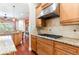 The kitchen features stainless steel appliances, granite countertops, and warm wood cabinetry, offering both style and functionality at 3300 Stonegate Falls Dr, Land O Lakes, FL 34638