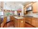 Spacious kitchen features granite countertops, stainless steel appliances, a central island, and warm wood cabinetry for a modern touch at 3300 Stonegate Falls Dr, Land O Lakes, FL 34638