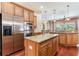 Modern kitchen featuring stainless steel appliances, granite countertops, and an island, perfect for cooking and entertaining guests at 3300 Stonegate Falls Dr, Land O Lakes, FL 34638