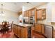 Open kitchen with stainless steel appliances, granite countertops, a kitchen island, and seamless transition to the breakfast nook at 3300 Stonegate Falls Dr, Land O Lakes, FL 34638