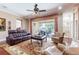 Spacious living room with a ceiling fan and access to the outdoor pool area, perfect for entertaining at 3300 Stonegate Falls Dr, Land O Lakes, FL 34638
