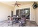 Covered patio with dining, ceiling fan, and sliding door access to the interior at 3300 Stonegate Falls Dr, Land O Lakes, FL 34638