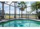 Screened in pool overlooks serene lake views at 3300 Stonegate Falls Dr, Land O Lakes, FL 34638