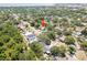 Aerial neighborhood view with a red arrow pointing to a charming home nestled among mature trees at 3316 W Napoleon Ave, Tampa, FL 33611