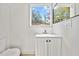 Clean half-bathroom with white vanity and modern fixtures at 3316 W Napoleon Ave, Tampa, FL 33611