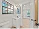 Bathroom features a modern vanity, mirror, and lighting fixture, with a view to another room at 3316 W Napoleon Ave, Tampa, FL 33611