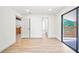 Light-filled bedroom with new floors, access to a balcony, and a view of the connected bathroom at 3316 W Napoleon Ave, Tampa, FL 33611