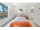 Cozy bedroom with a modern bed, decorative lamps, and view to the outside at 3316 W Napoleon Ave, Tampa, FL 33611