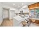 Updated kitchen featuring white cabinetry, quartz countertops, and a cozy breakfast nook at 3316 W Napoleon Ave, Tampa, FL 33611