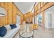 Spacious living room with high ceilings, wood paneling, modern furniture, and ample natural light at 3316 W Napoleon Ave, Tampa, FL 33611