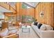 Bright living room with vaulted ceilings, wood paneling, and large windows for natural light at 3316 W Napoleon Ave, Tampa, FL 33611