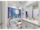 Cozy bathroom featuring a light-colored vanity and decorative winter themed shower curtain at 3329 Fresno Pl, Zephyrhills, FL 33541