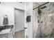 Bathroom featuring a walk-in shower and a vanity with granite countertop and hardwood floors at 3402 W Clifton St, Tampa, FL 33614