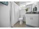 Clean bathroom featuring modern fixtures, a white vanity, and a shower with a white curtain at 3402 W Clifton St, Tampa, FL 33614