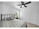 Comfortable bedroom featuring a ceiling fan, wood flooring, and a window for plenty of natural light at 3402 W Clifton St, Tampa, FL 33614