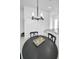 Bright dining area features modern chandelier, black table with seating, and white walls at 3402 W Clifton St, Tampa, FL 33614