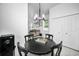 Bright dining area features a modern chandelier, a black table with seating for four at 3402 W Clifton St, Tampa, FL 33614