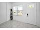 Bright entryway featuring white marble floors, a modern accent shelf, and natural light from the front window at 3402 W Clifton St, Tampa, FL 33614