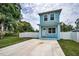 Charming two-story home featuring a quaint front porch, private white fence, and spacious front driveway at 3402 W Clifton St, Tampa, FL 33614