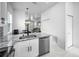 Open concept kitchen features stainless steel appliances, granite countertops, and white cabinetry at 3402 W Clifton St, Tampa, FL 33614