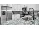 Modern kitchen features granite countertops, stainless steel appliances, and a mosaic backsplash at 3402 W Clifton St, Tampa, FL 33614