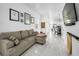 Open-concept living room leading to the kitchen and dining area featuring marble floors and comfortable furnishings at 3402 W Clifton St, Tampa, FL 33614