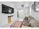Contemporary living room boasts marble floors, recessed lighting, modern furniture, and a mounted flatscreen TV at 3402 W Clifton St, Tampa, FL 33614