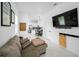 Open-concept living room leading to the kitchen and dining area featuring marble floors and comfortable furnishings at 3402 W Clifton St, Tampa, FL 33614