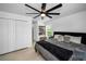 Large bedroom with a walk-in closet, ceiling fan, and modern decor and hardwood floors at 3402 W Clifton St, Tampa, FL 33614