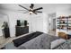 Cozy bedroom with modern ceiling fan, closet and open shoe shelves with hardwood floors at 3402 W Clifton St, Tampa, FL 33614