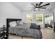 Spacious bedroom with a black accent wall, natural light, and contemporary decor and hardwood floors at 3402 W Clifton St, Tampa, FL 33614