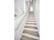 Stylish staircase with wood treads and white risers leading to the upper level of the home at 3402 W Clifton St, Tampa, FL 33614