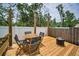 Relaxing deck area featuring an outdoor table and chairs, a fire pit, and a beautiful backyard view at 3402 W Clifton St, Tampa, FL 33614