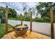 Outdoor seating area with a table and chairs, a fire pit, and a view of the backyard greenery at 3402 W Clifton St, Tampa, FL 33614