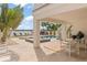 Beautiful backyard pool area with tiled patio, lounge chairs, and lush landscaping with water views at 371 12Th Ave, Indian Rocks Beach, FL 33785