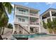 Gorgeous pool and backyard with multiple balconies with a view of the pool and spa at 371 12Th Ave, Indian Rocks Beach, FL 33785