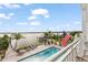 Beautiful backyard featuring a pool, lounge area, and dock with Gulf access at 371 12Th Ave, Indian Rocks Beach, FL 33785