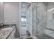 Bright bathroom featuring marble shower and countertop, and view into bedroom at 371 12Th Ave, Indian Rocks Beach, FL 33785